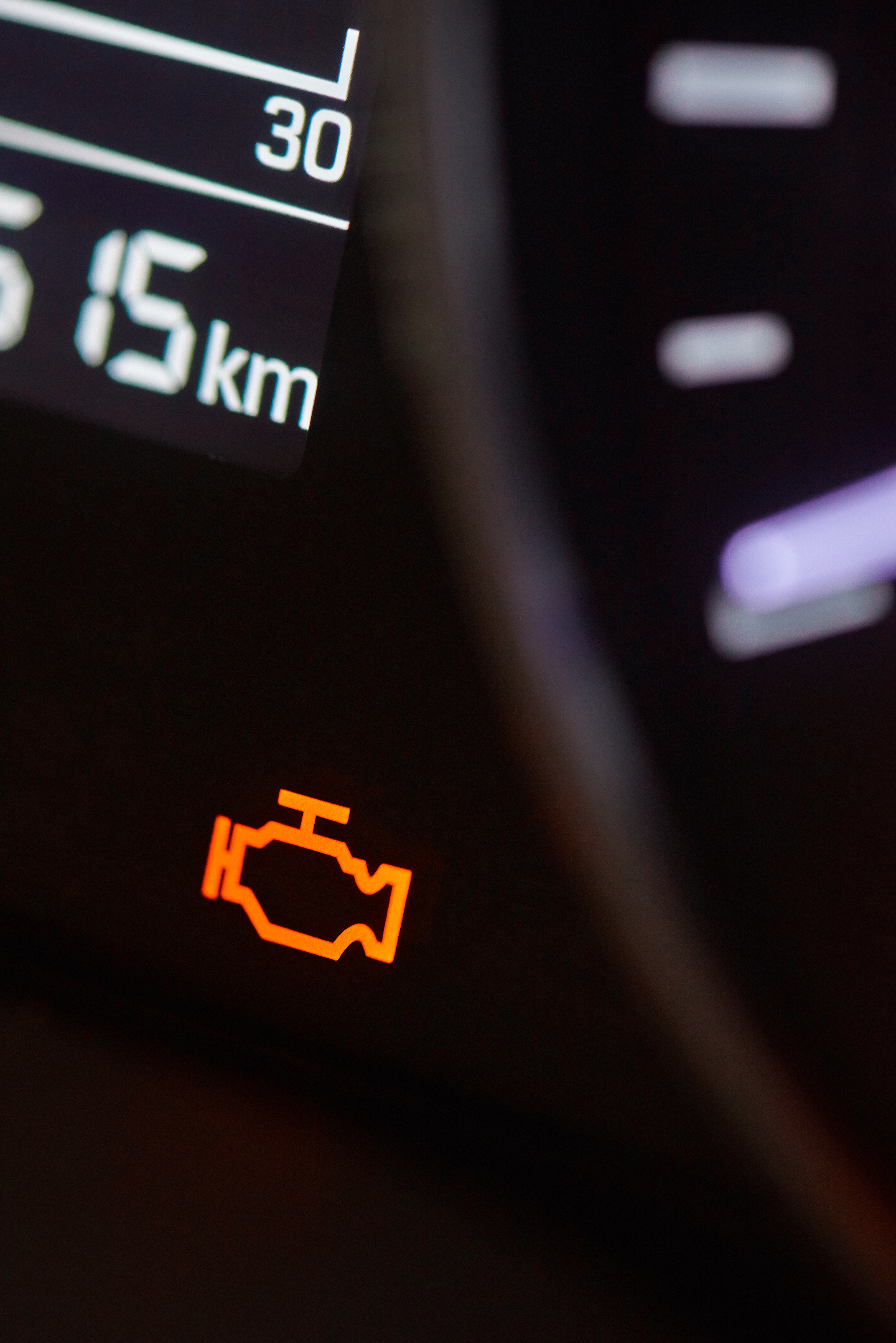 An engine warning sign on the dashboard of a vehicle.